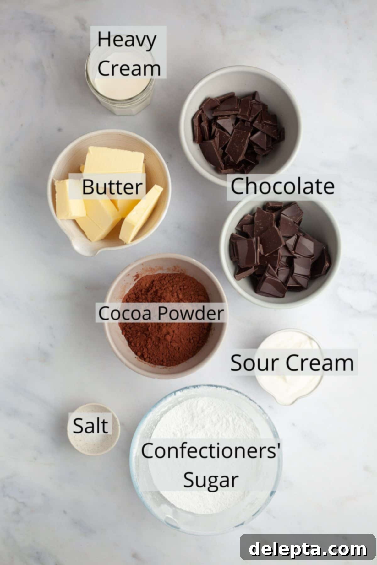 Ultimate Triple Chocolate Indulgence 4 All the ingredients needed to create the rich chocolate ganache filling and the creamy chocolate sour cream frosting, presented in separate bowls.