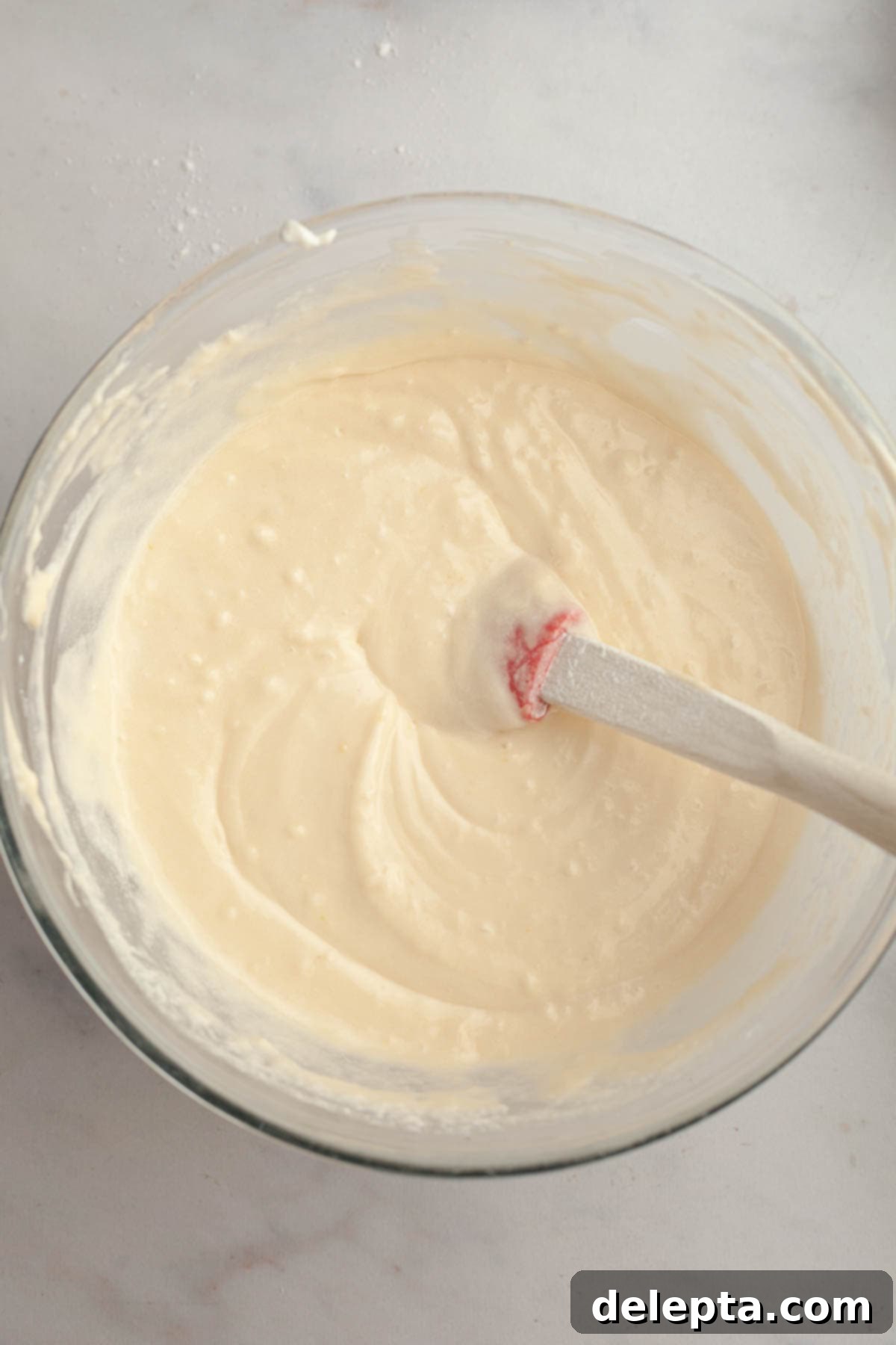Velvety Vanilla, Chocolate Bliss 6 Smooth, light-colored cupcake batter in a large mixing bowl, recently combined with dry ingredients, demonstrating the correct consistency before adding milk.