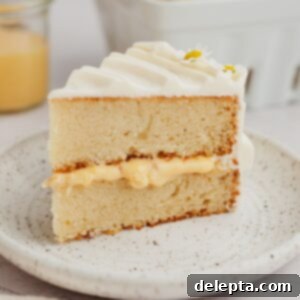 Zesty Lemon Curd Delight 13 A slice of lemon curd cake on a small plate.