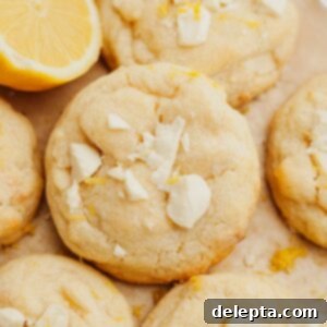 Sunshine Lemon White Chocolate Delights 9 Lemon white chocolate cookies on light brown parchment paper.