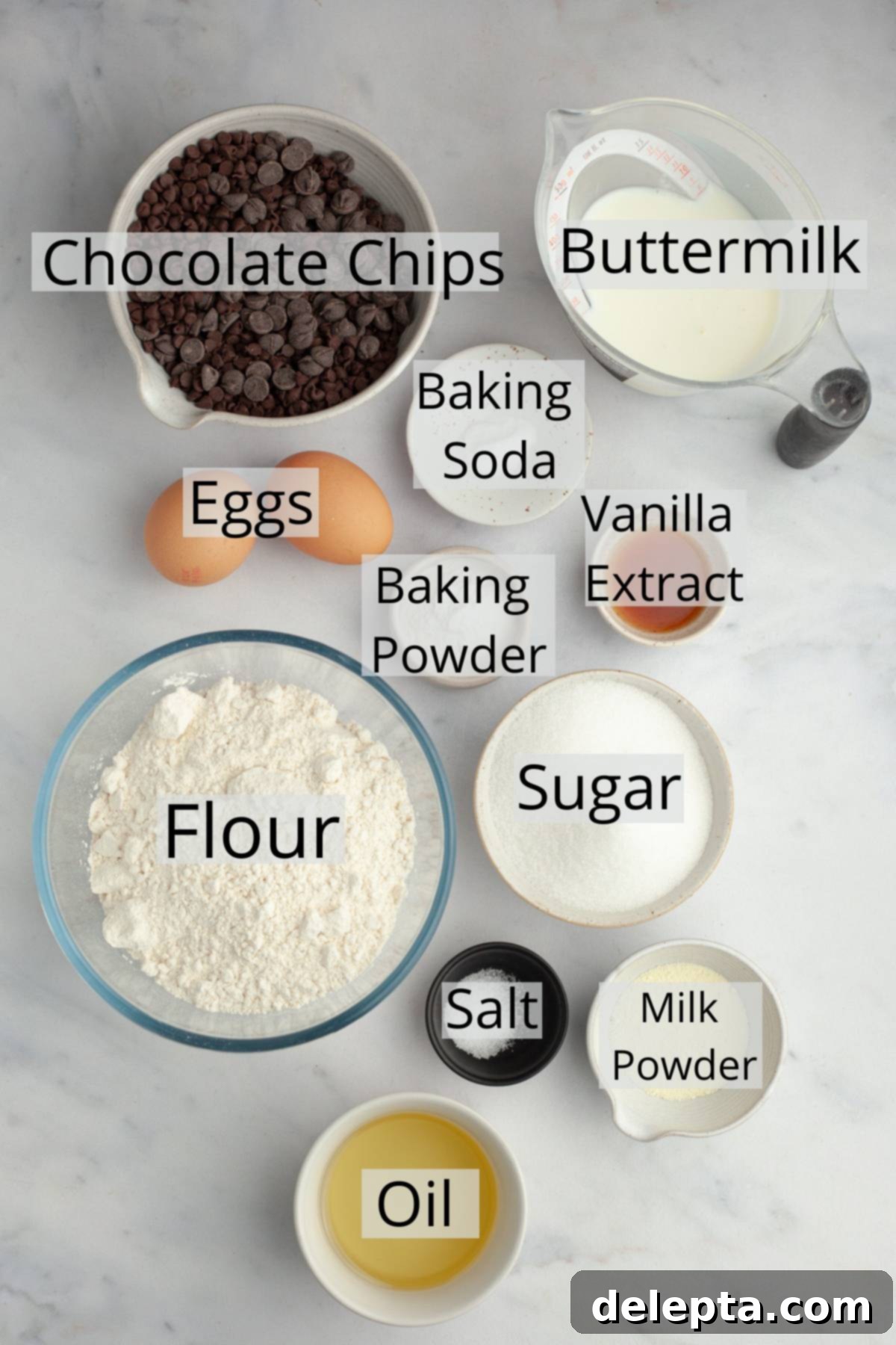 Mile-High Chocolate Chip Muffins 3 All the essential ingredients for bakery style chocolate chip muffins, meticulously measured out into small bowls, ready for mixing.