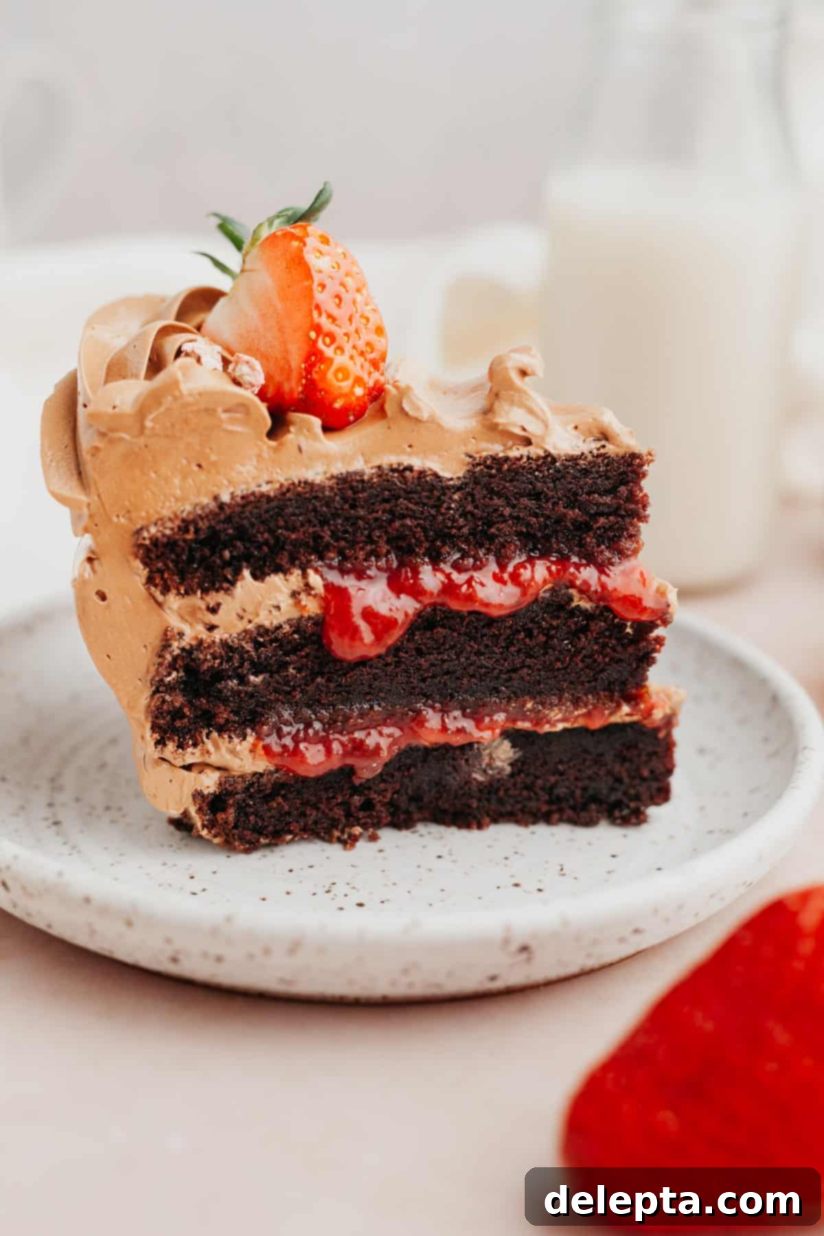 Decadent Chocolate Strawberry Cake 11 A beautiful slice of chocolate cake with strawberry filling and chocolate frosting, showcasing its delicious layers and perfect texture.