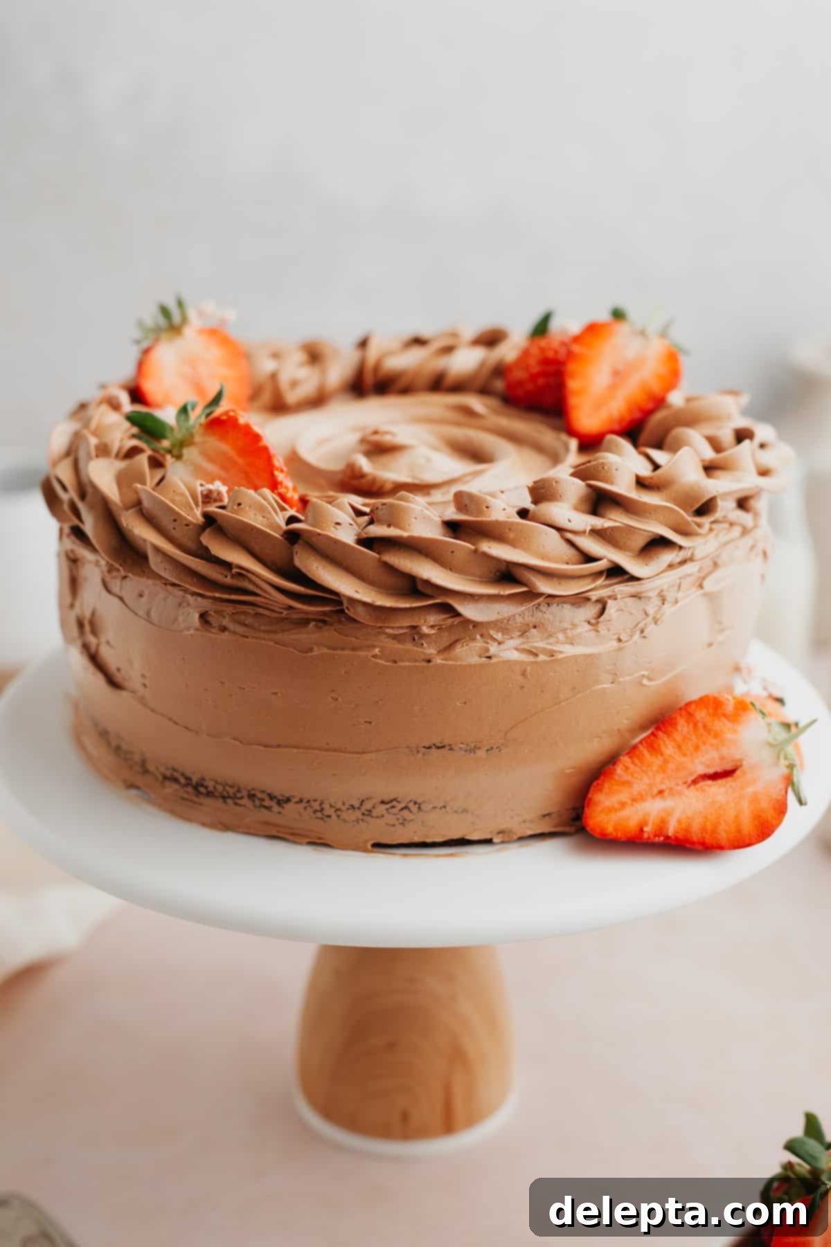 Decadent Chocolate Strawberry Cake 10 A beautifully decorated chocolate cake with fresh strawberries on a white cake stand, ready to be served.