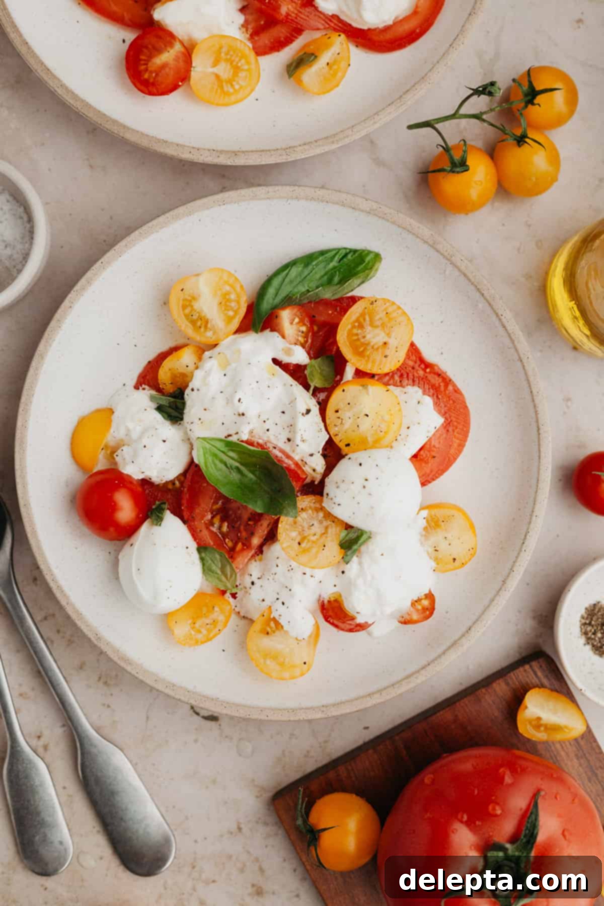 Fresh Burrata Caprese 2 A burrata caprese salad on a small plate.