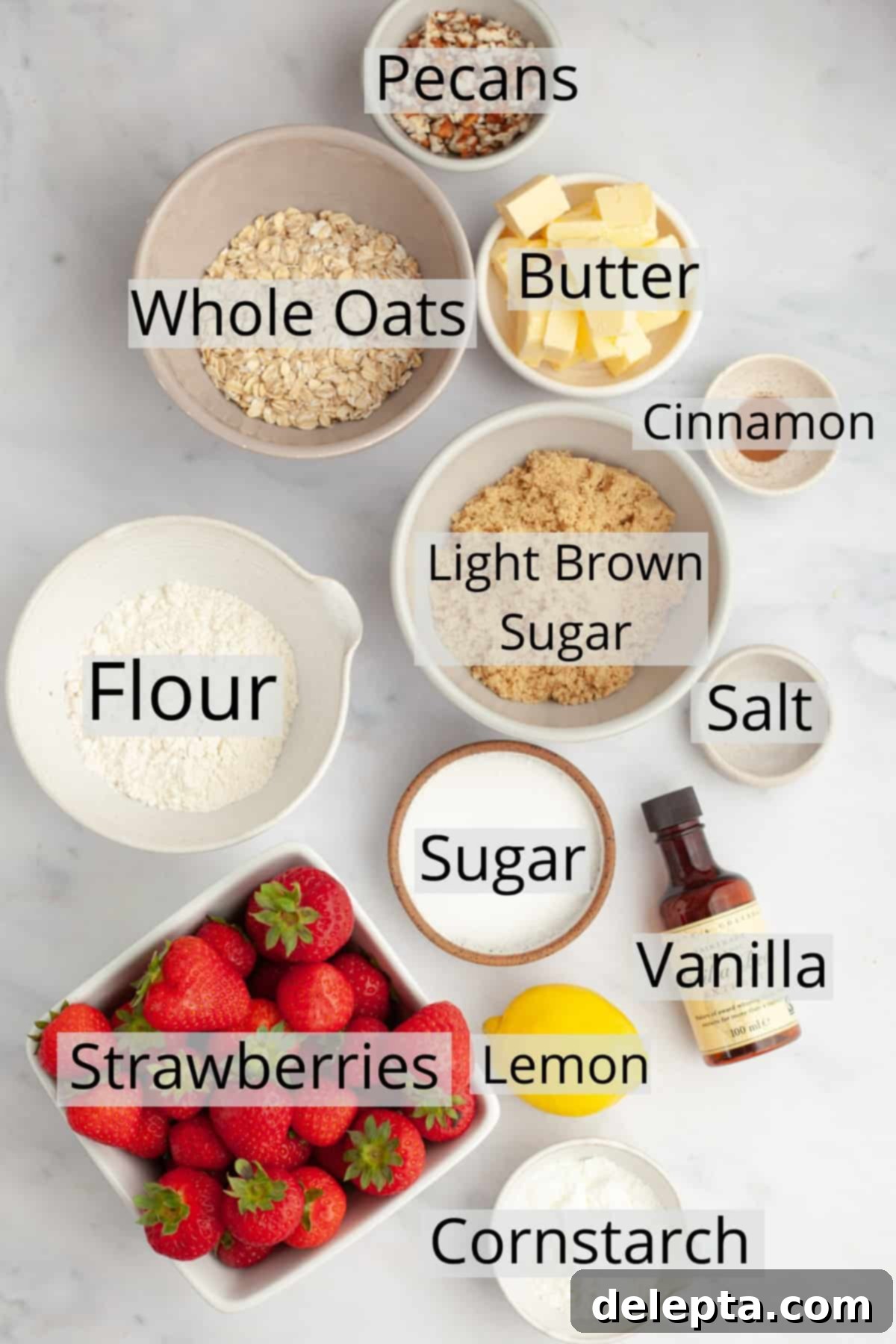 Strawberry Sunshine Crumble 3 All the ingredients neatly weighed out and displayed in small bowls, ready to make the strawberry crisp: fresh strawberries, oats, flour, sugar, cornstarch, butter, lemon, and pecans.