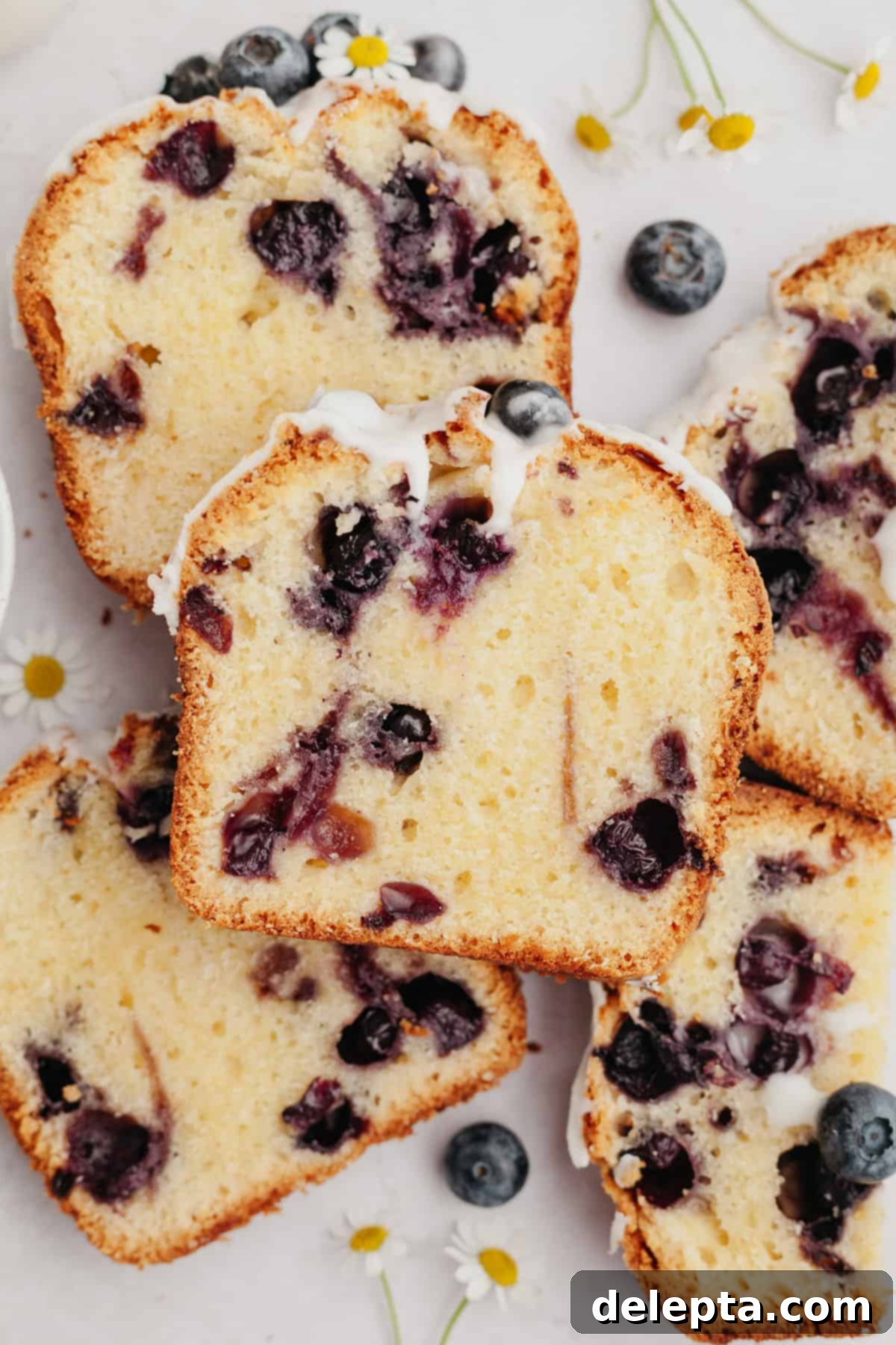 Heavenly Blueberry Pound Cake 8 Stacked slices of moist blueberry loaf cake, showing its tender crumb and rich glaze.
