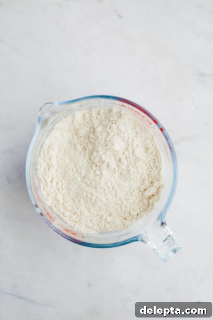 Ultimate Tiramisu Layer Cake 5 A large glass jug with flour in it