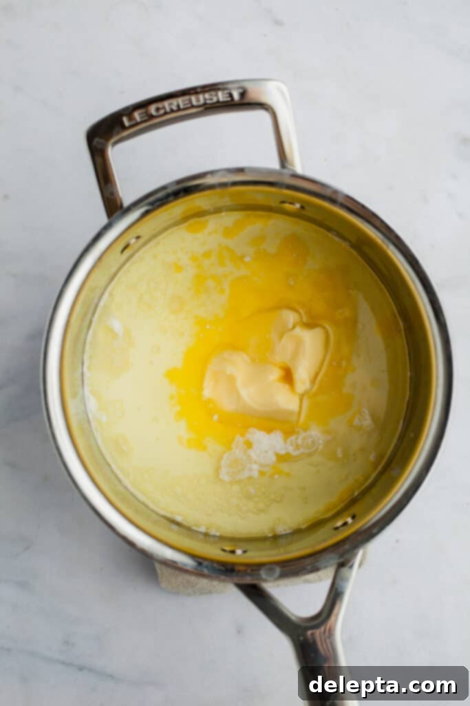 Ultimate Tiramisu Layer Cake 8 A small saucepan with melted butter and milk