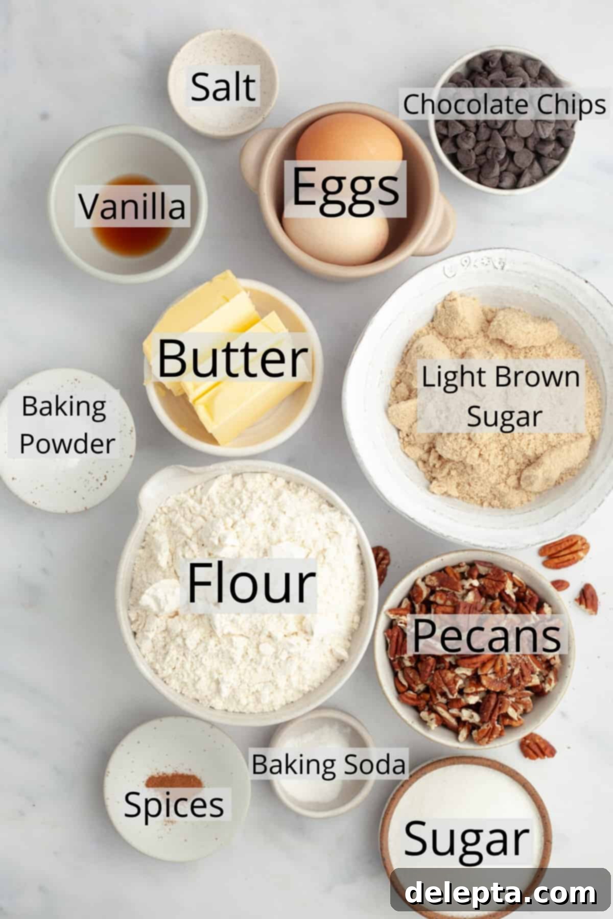 Decadent Chocolate Pecan Cookies 3 All the ingredients needed to make chocolate chip pecan cookies, weighed out into small bowls, including flour, sugars, butter, eggs, chocolate chips, and chopped pecans.