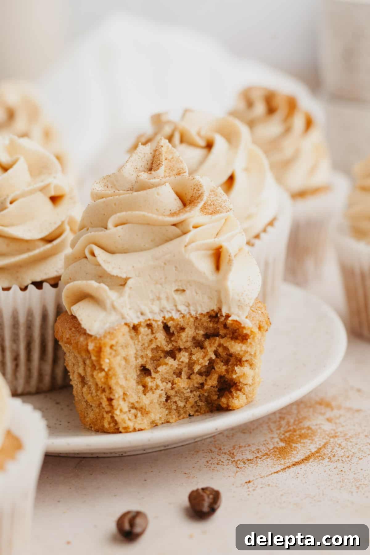 Quick Coffee Cupcake Fix 2 A close up of a coffee cupcake with a bite taken out of it, showcasing its moist texture and creamy espresso frosting.