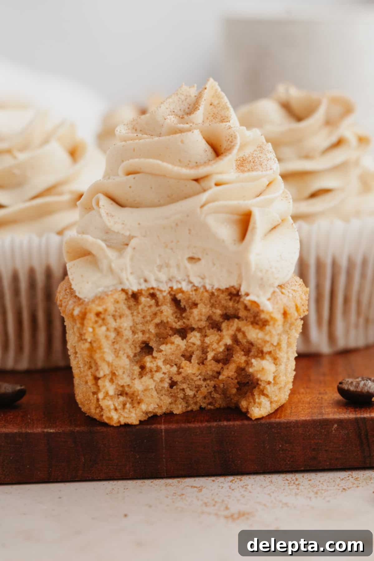 Quick Coffee Cupcake Fix 9 A close up of an espresso cupcake with a bite taken out of it.