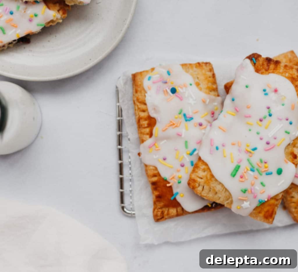 Artisan Blueberry Toaster Treats 4 two blueberry pop tarts on a small metal grill, with a glass of milk
