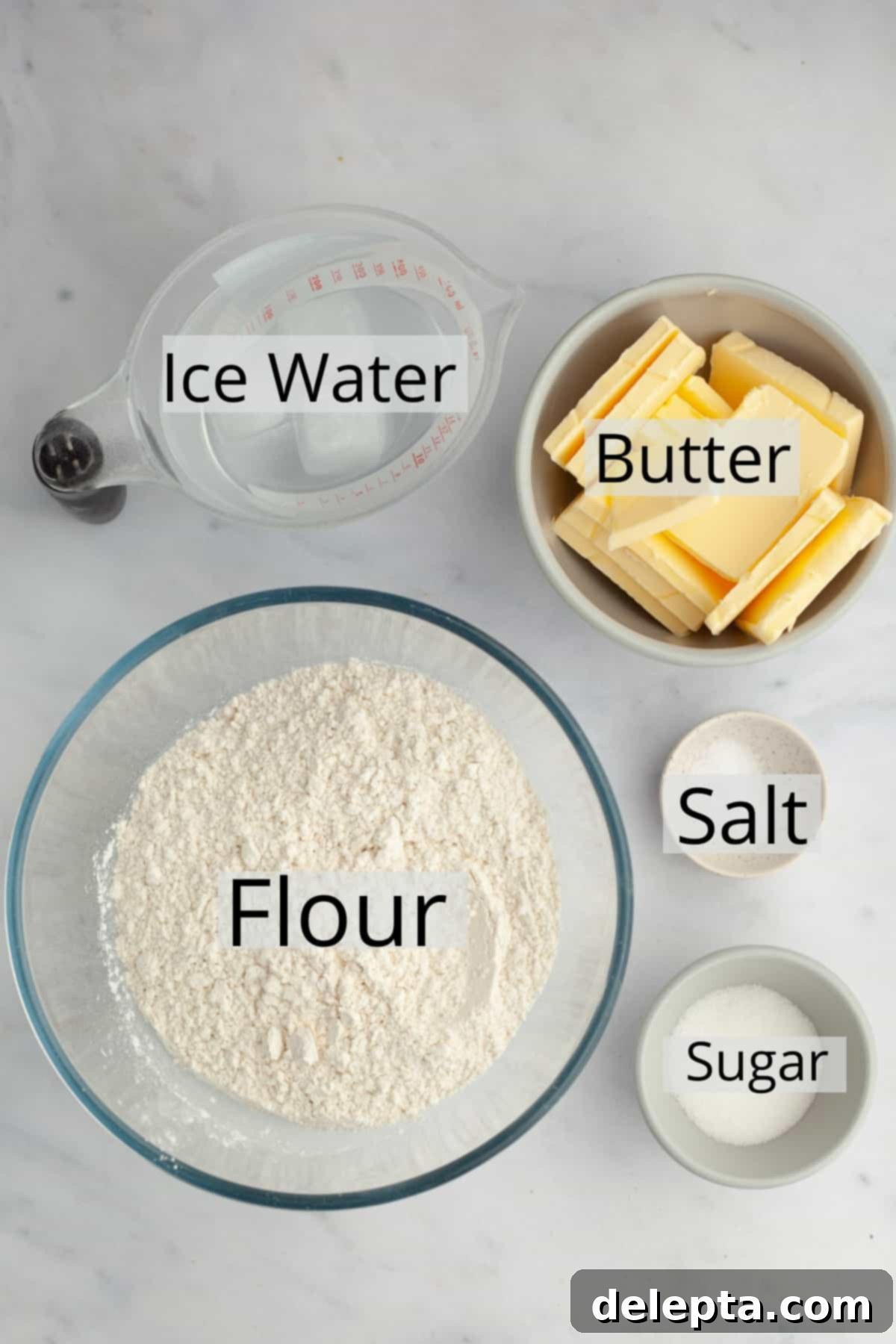 Perfectly Flaky Homemade Pie Crust 3 All the essential ingredients needed to make a pie crust, meticulously weighed out into small bowls, ready for mixing.