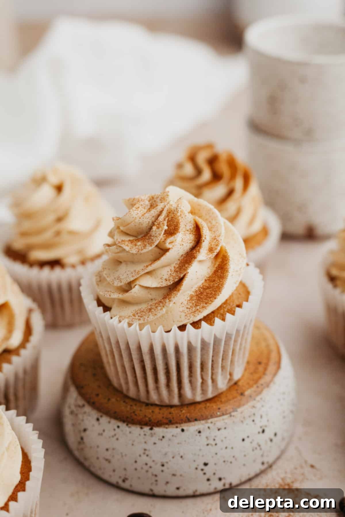 Java Velvet 2 A close up of an espresso cupcake on an upturned bowl, showcasing the rich coffee buttercream frosting.