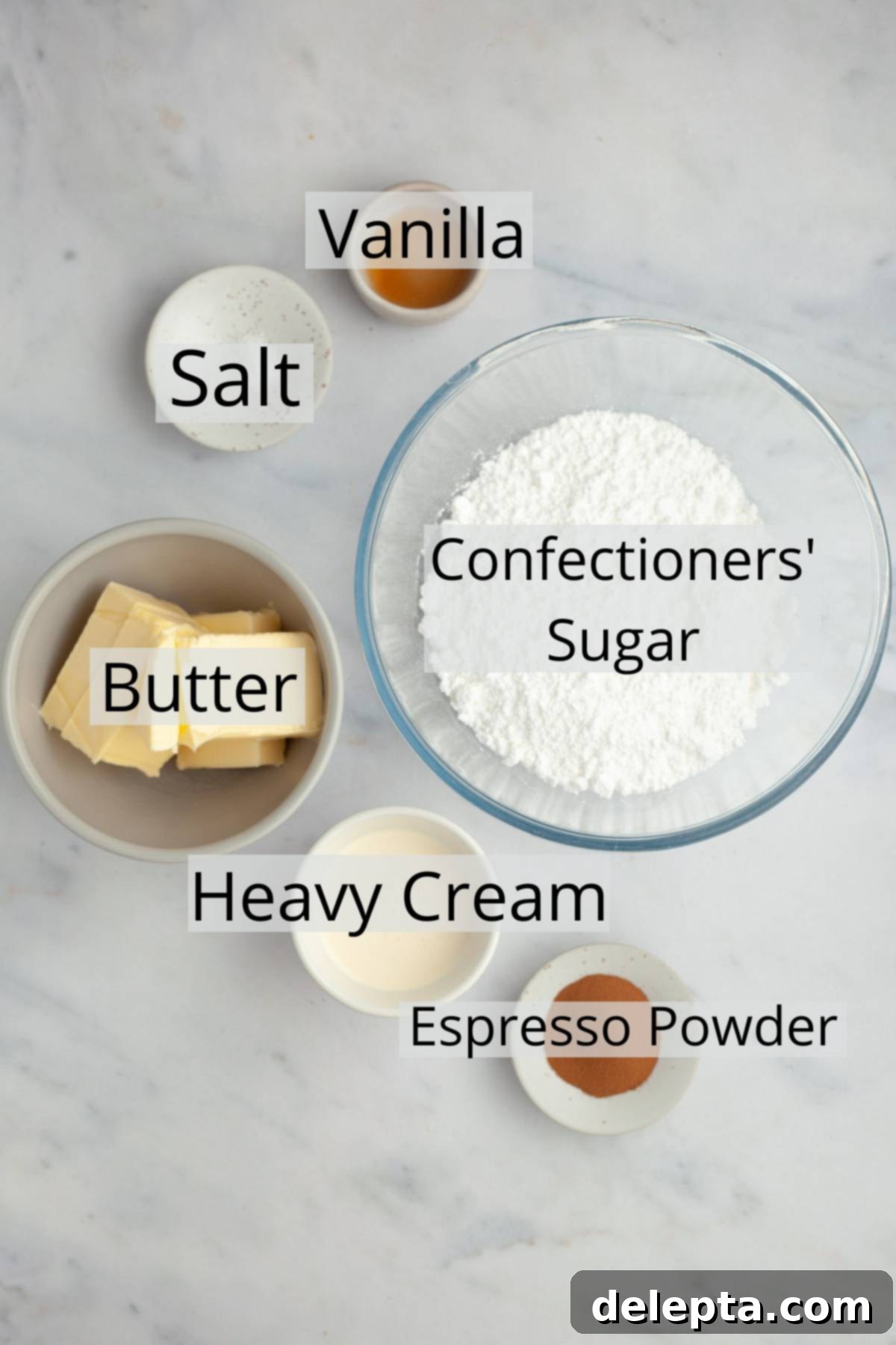 Java Velvet 3 Ingredients needed to make espresso buttercream, precisely weighed out into small white bowls on a light wooden surface.