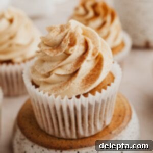 Java Velvet 6 A close up of a coffee cupcake with coffee buttercream, garnished with a single coffee bean.