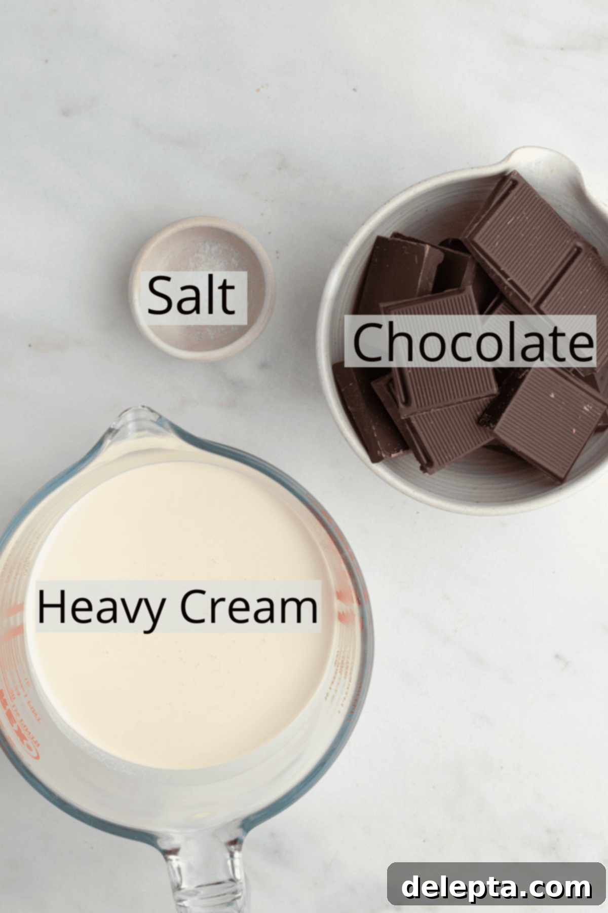 Effortless Whipped Ganache for Bakery-Worthy Cakes 3 Close-up shot of the three essential ingredients: heavy cream, semi-sweet chocolate bar, and a pinch of salt, neatly arranged.