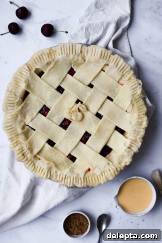 Luscious Homemade Kirsch and Vanilla Cherry Pie 2 Freshly baked cherry pie with golden crust on a wire rack