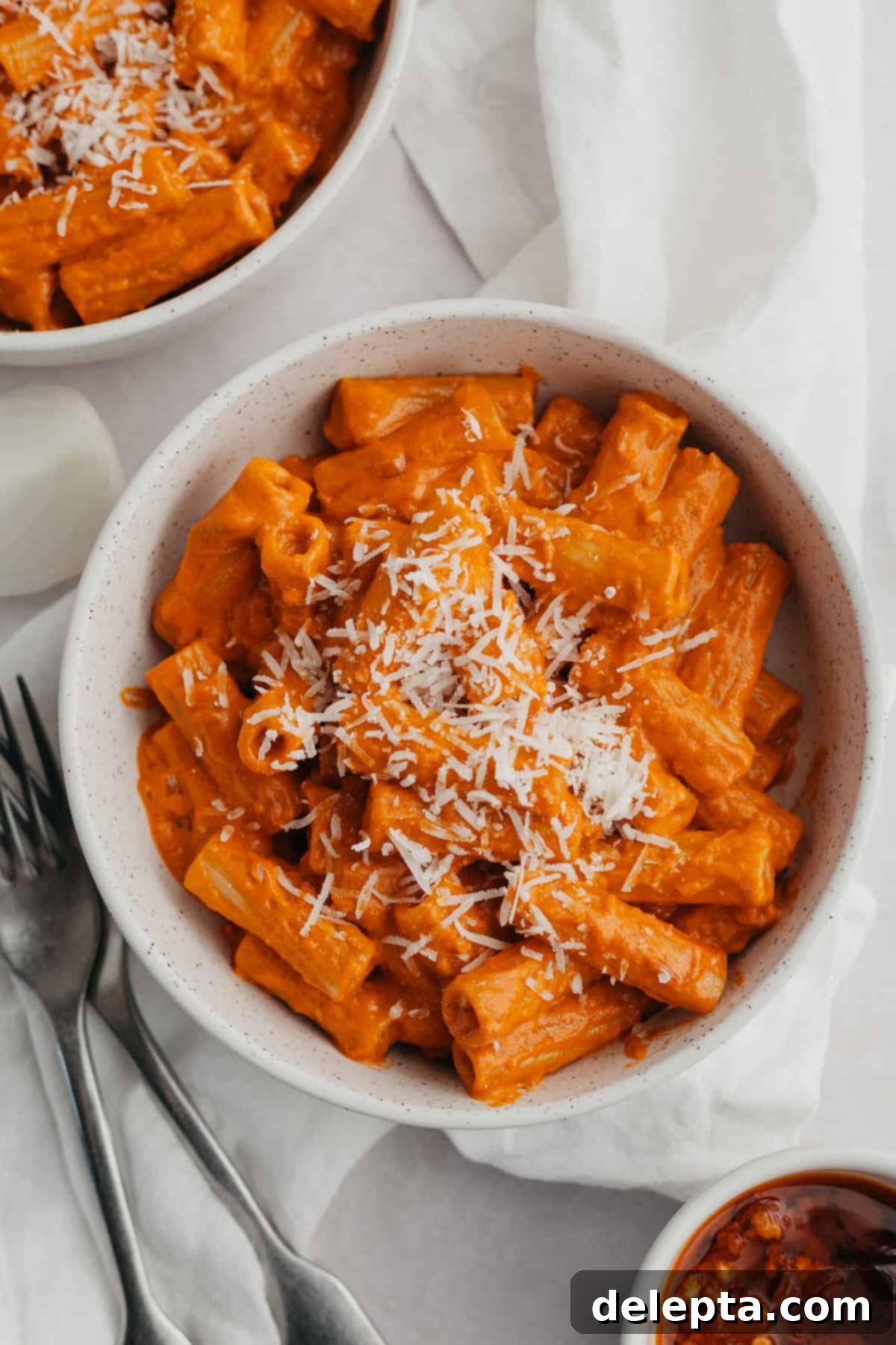 Viral Easy Spicy Vodka Pasta 2 A white bowl with vodka pasta in it garnished with extra parmesan.