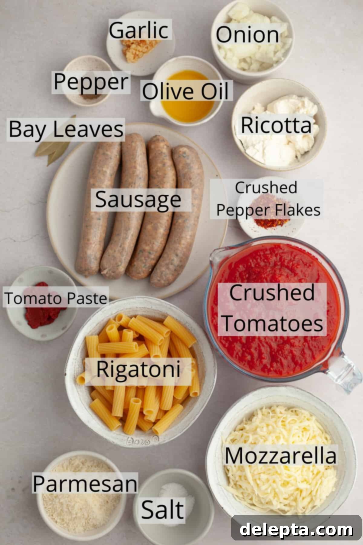 Hearty Three-Cheese Baked Rigatoni with Savory Sausage 3 All the fresh and pantry ingredients laid out in small bowls, ready for making rigatoni al forno.