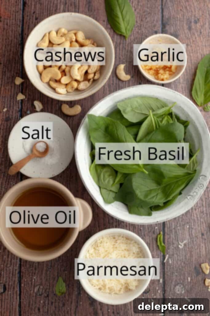 Homemade Pesto Pasta 3 All the ingredients needed to make cashew pesto weighed out into small bowls, showcasing fresh basil, cashews, garlic, parmesan, and olive oil.