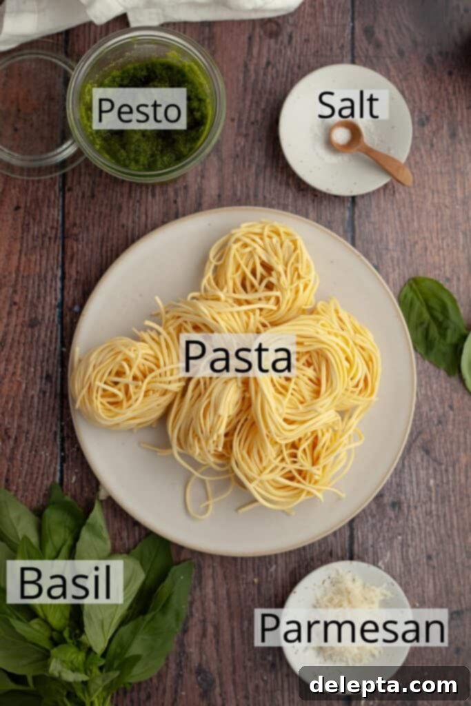 Homemade Pesto Pasta 4 All the ingredients needed to make pesto pasta, including a bundle of fresh spaghetti, a jar of pesto, and a block of parmesan.
