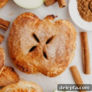 Flaky Apple Puff Pastry Bites 8 A close up of an apple shaped mini apple pie, golden brown and perfectly baked.