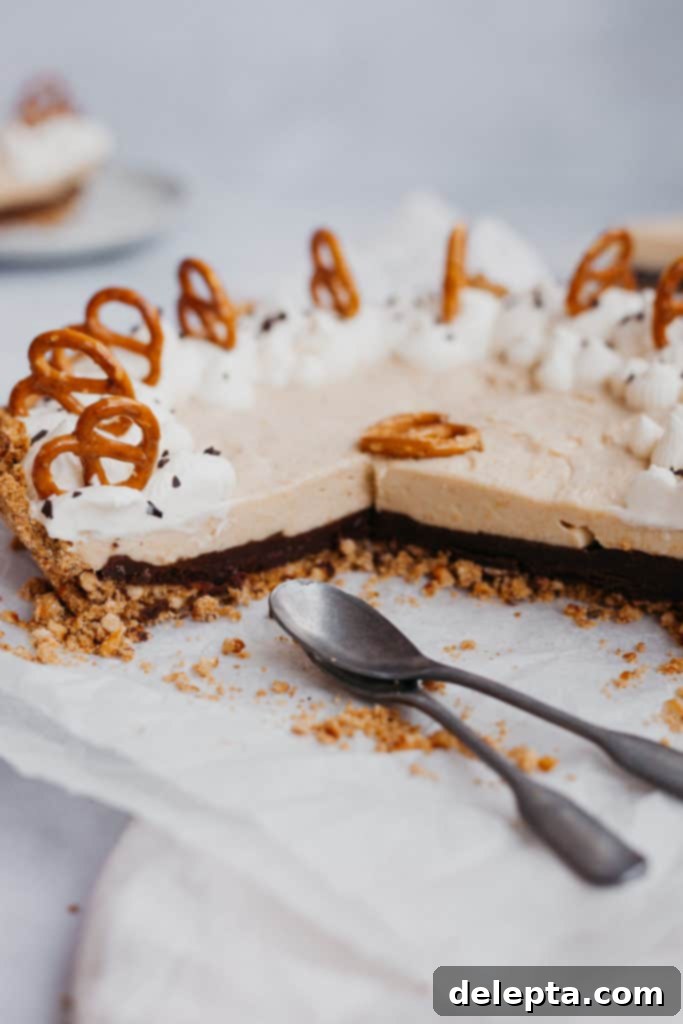 Salty-Sweet Chocolate Butterscotch Pretzel Pie 2 Side angle view of a butterscotch pie with a ganache bottom and pretzel crust