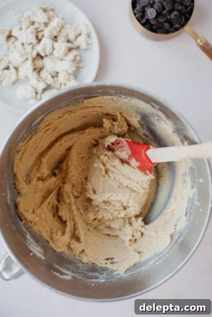 Halva Chocolate Chip Cookie Giants 4 Overhead view of perfectly mixed, fluffy cookie dough in a stand mixer bowl, showing its light texture.