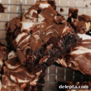 Swirled Marshmallow Dream Brownies 9 Marshmallow swirl brownies, perfectly fudgy, cooling on a wire rack, ready to be enjoyed.