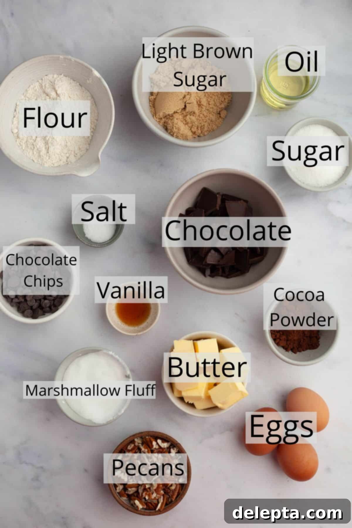 Swirled Marshmallow Dream Brownies 3 All the ingredients needed for marshmallow fluff brownies weighed out into small bowls, including chocolate, butter, flour, sugar, and marshmallow fluff.