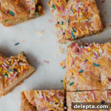 Sprinkle-Studded Golden Oreo Gooey Bars 14 overhead shot of funfetti bars cut into squares
