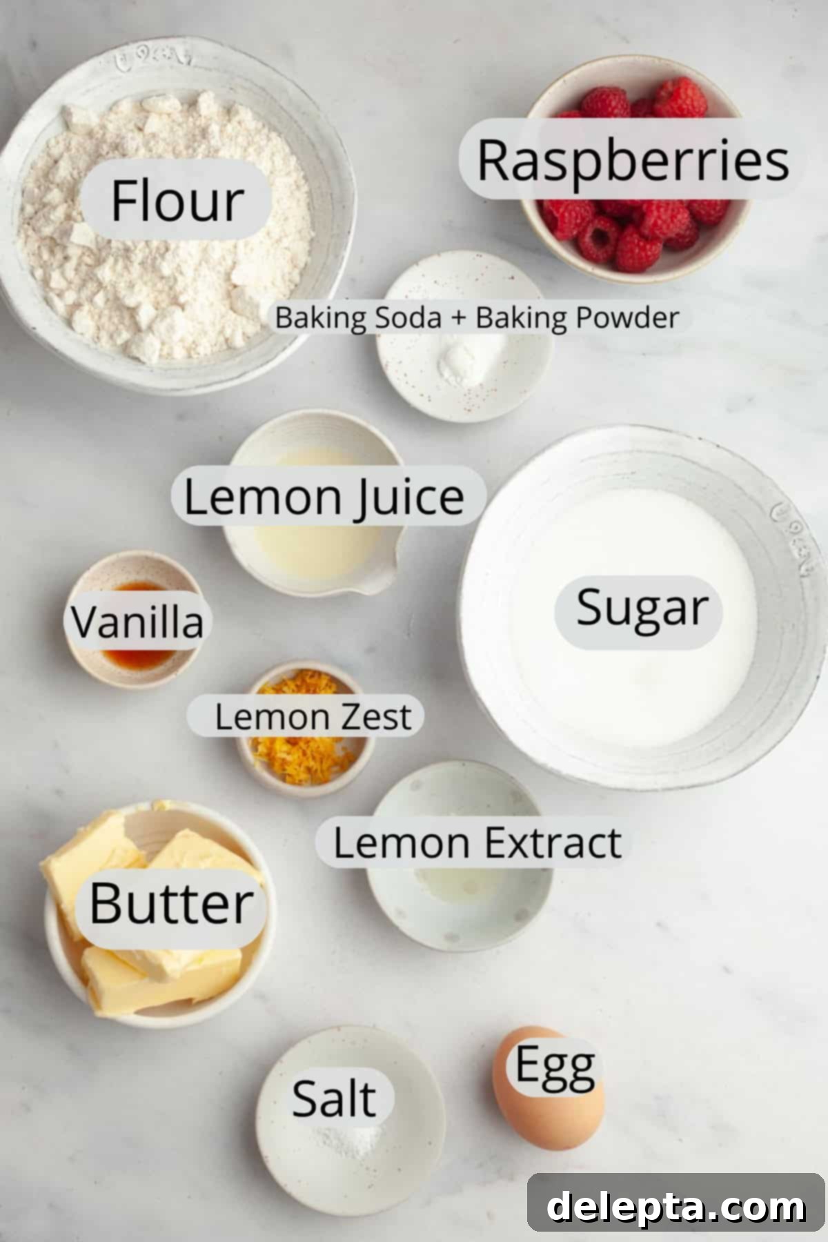 Easy One Bowl Lemon Raspberry Cookies 3 All the ingredients needed to make lemon raspberry cookies, weighed out into small bowls. Including flour, sugar, butter, eggs, lemons, and fresh raspberries.
