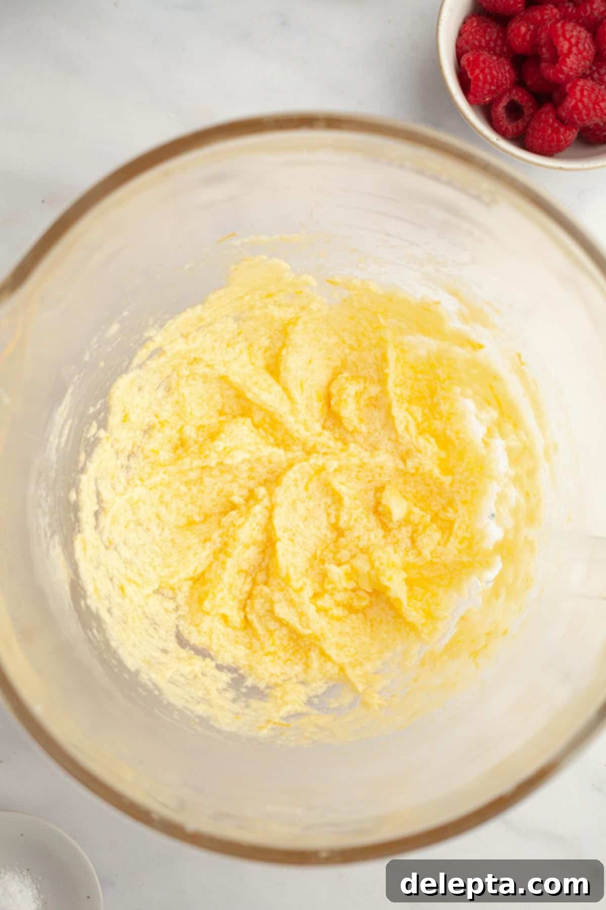 Easy One Bowl Lemon Raspberry Cookies 6 Lemon cookie batter in a bowl. It's a pale yellow color.