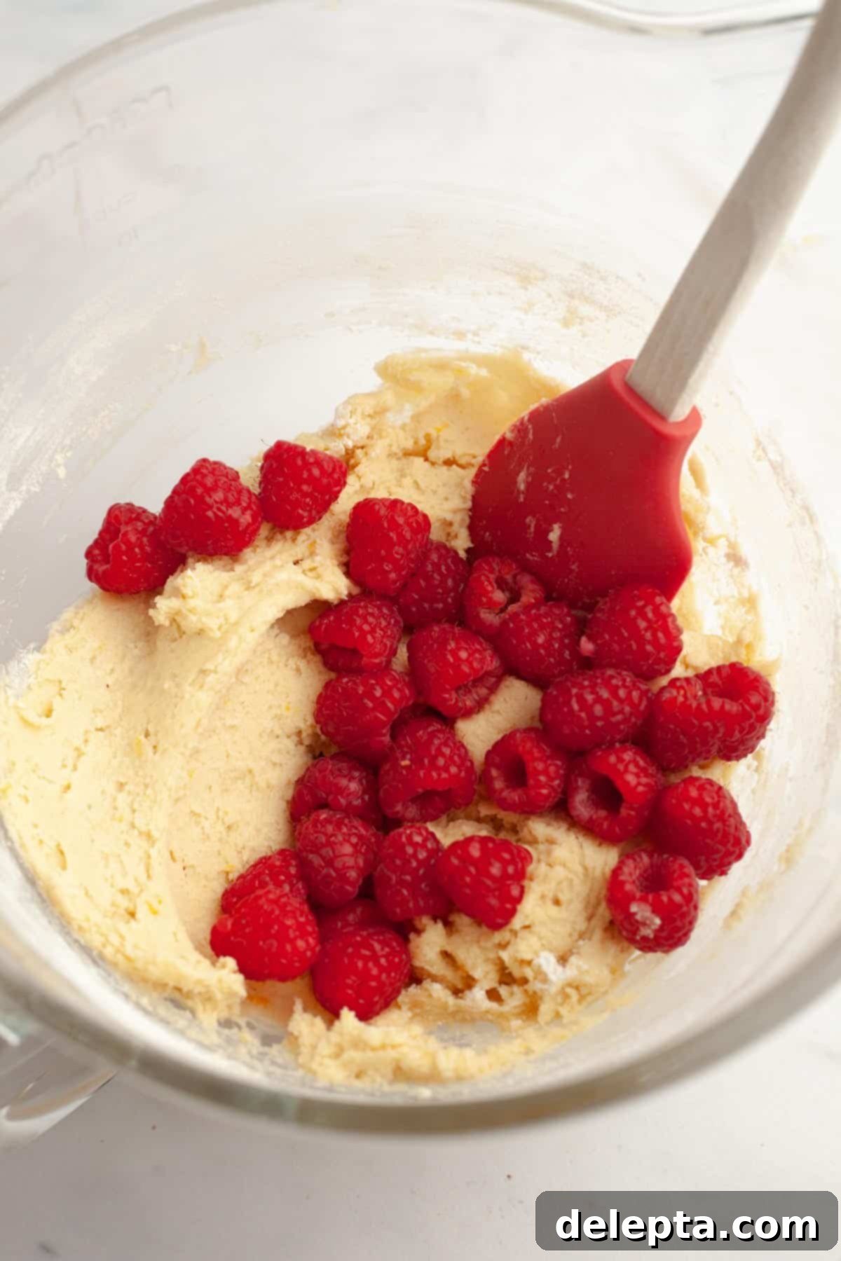 Easy One Bowl Lemon Raspberry Cookies 8 Lemon cookie batter in a bowl with raspberries folded in.