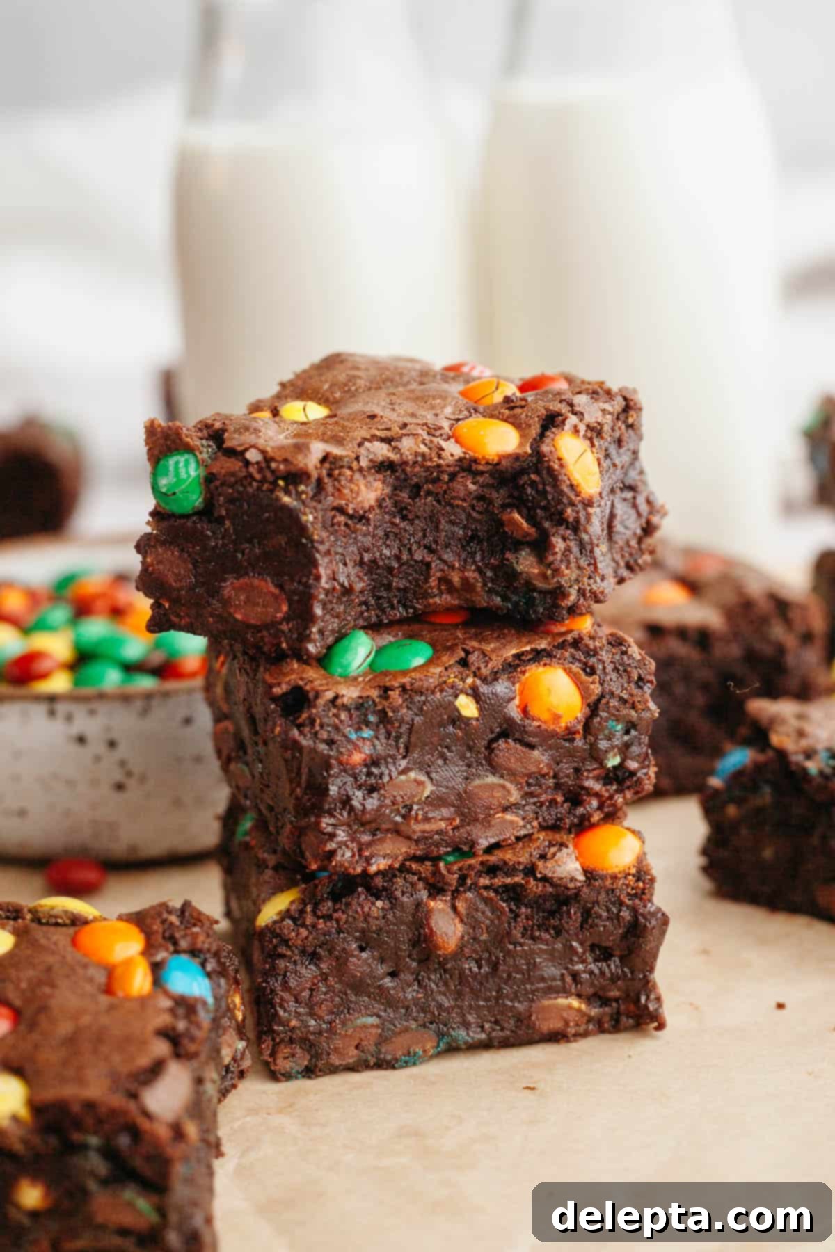 Fudgy M and M Brownies 2 A stack of M&M brownies, the brownie on top has a bite taken out of it.
