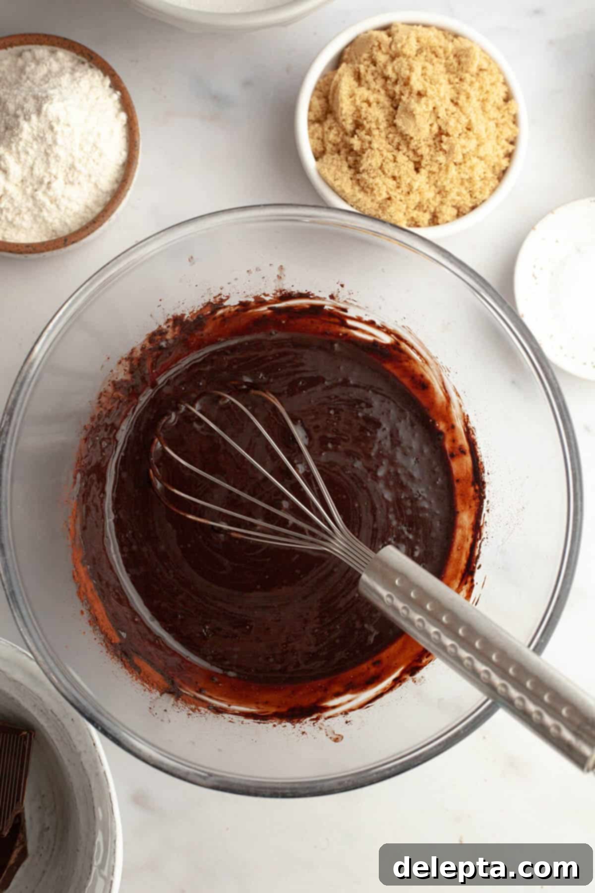 Fudgy M and M Brownies 4 Melted chocolate and butter in a bowl with a whisk.
