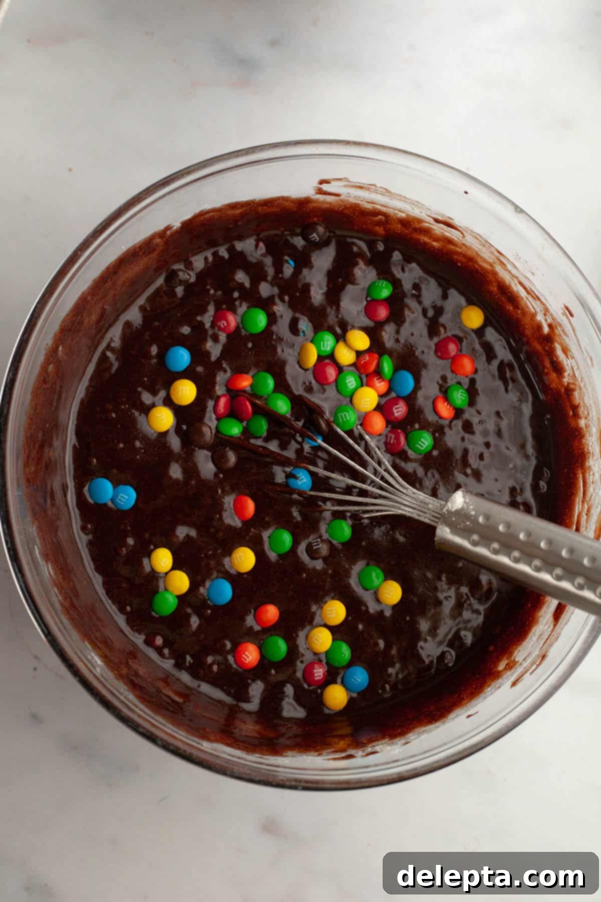 Fudgy M and M Brownies 8 M&M brownie batter in a glass bowl.