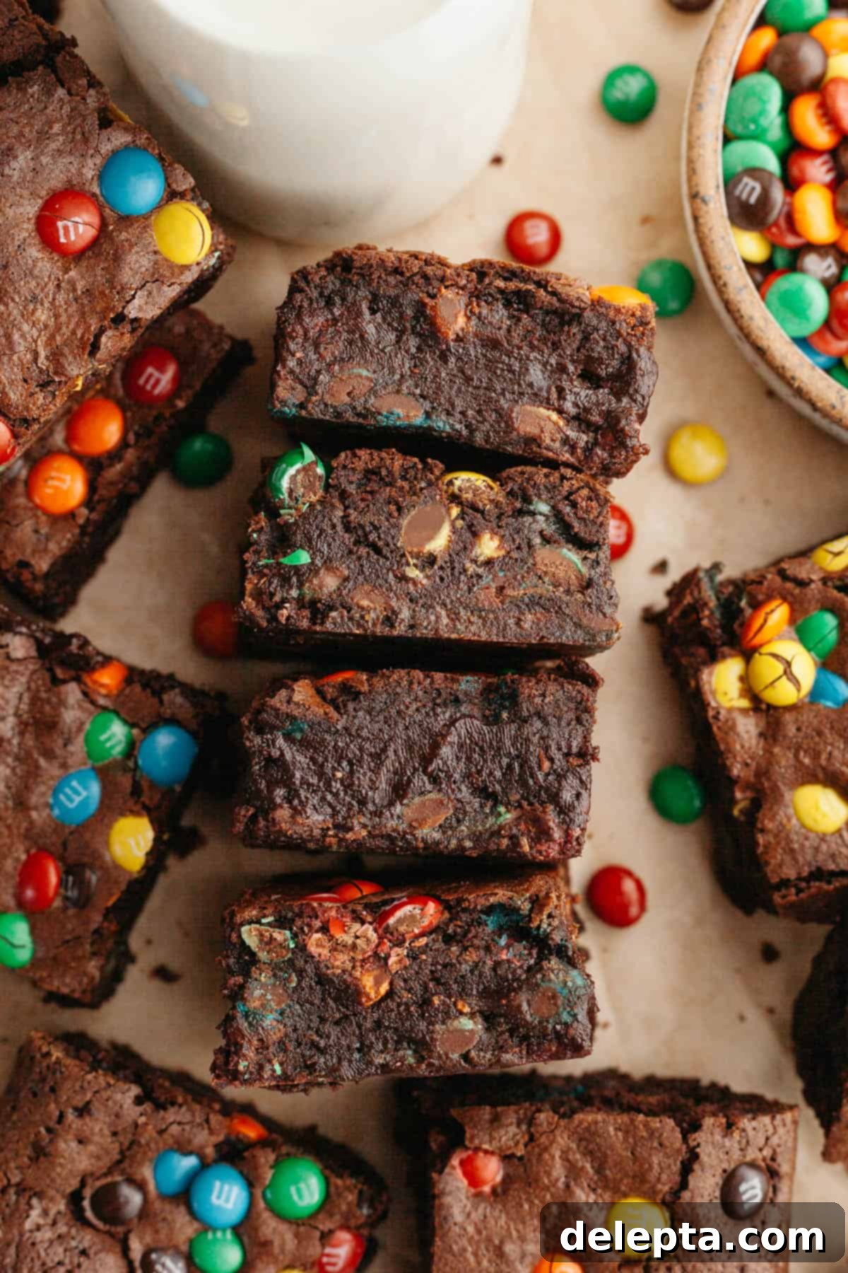Fudgy M and M Brownies 10 M&M brownies on parchment paper.
