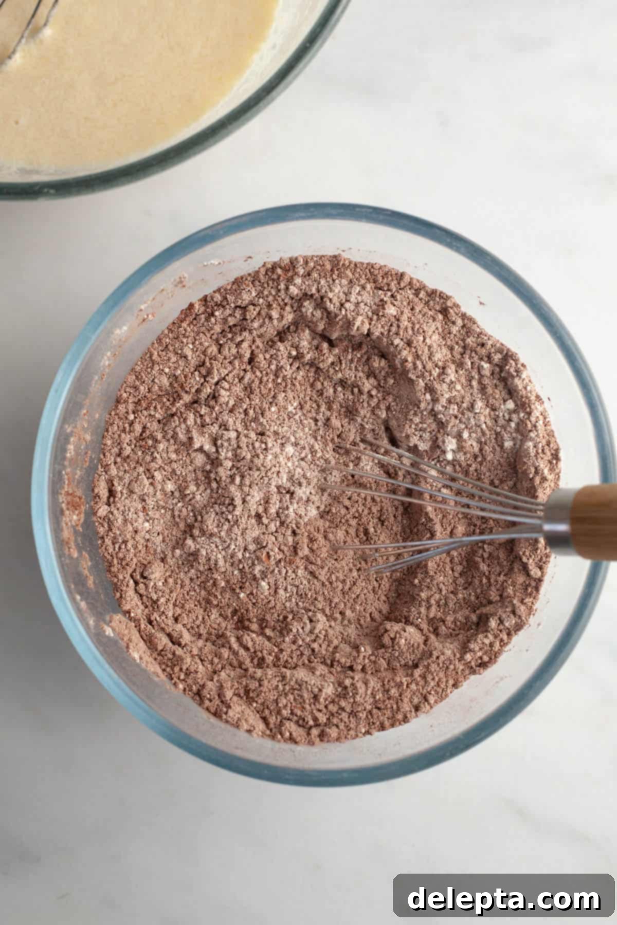 Velvet Chocolate Cupcakes with Tangy Cream Cheese Swirl 4 Cocoa powder and flour in a bowl being whisked together.