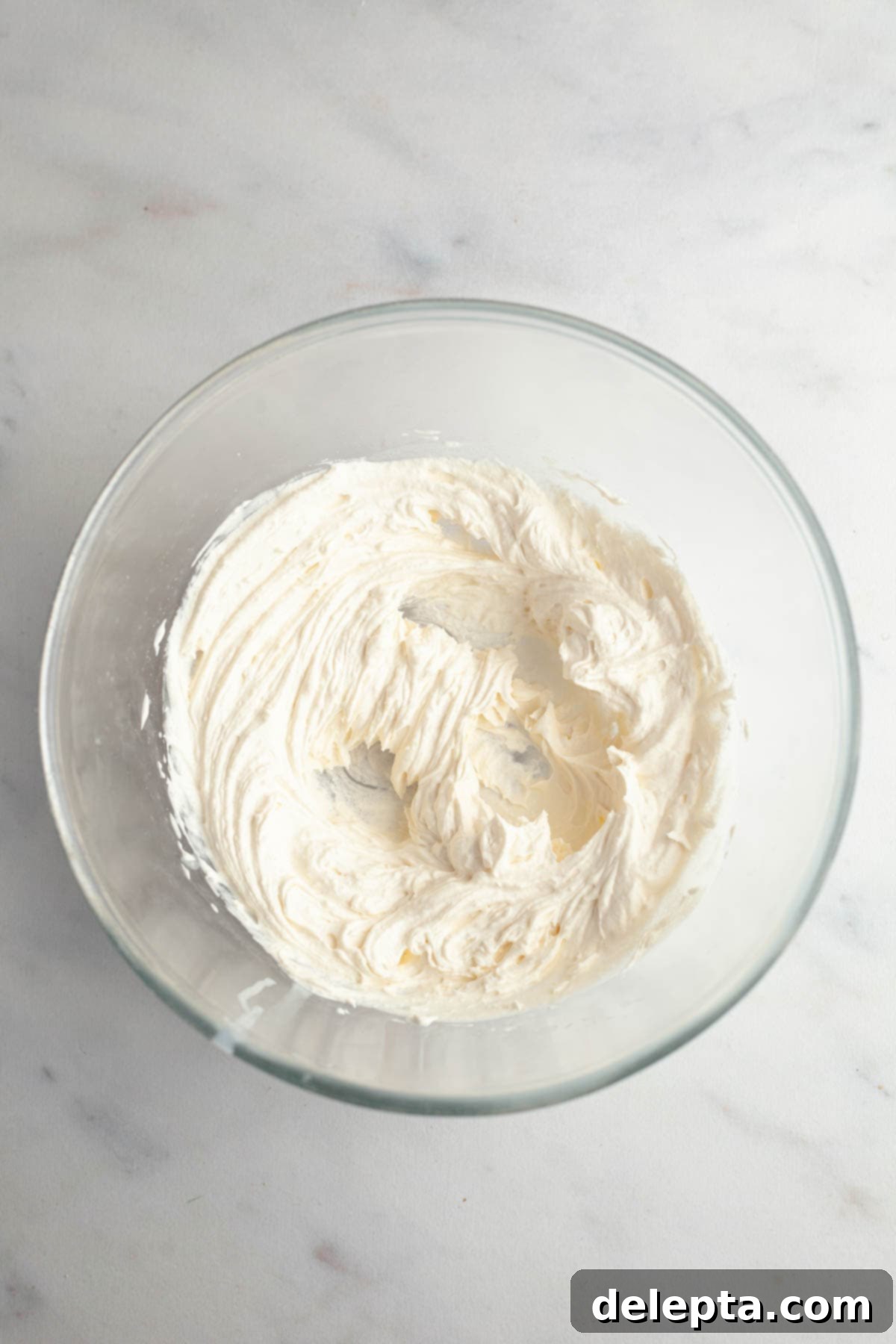 Perfect Butter-Free Cream Cheese Frosting in Minutes 4 A bowl with perfectly whipped cream, ready for the next step.
