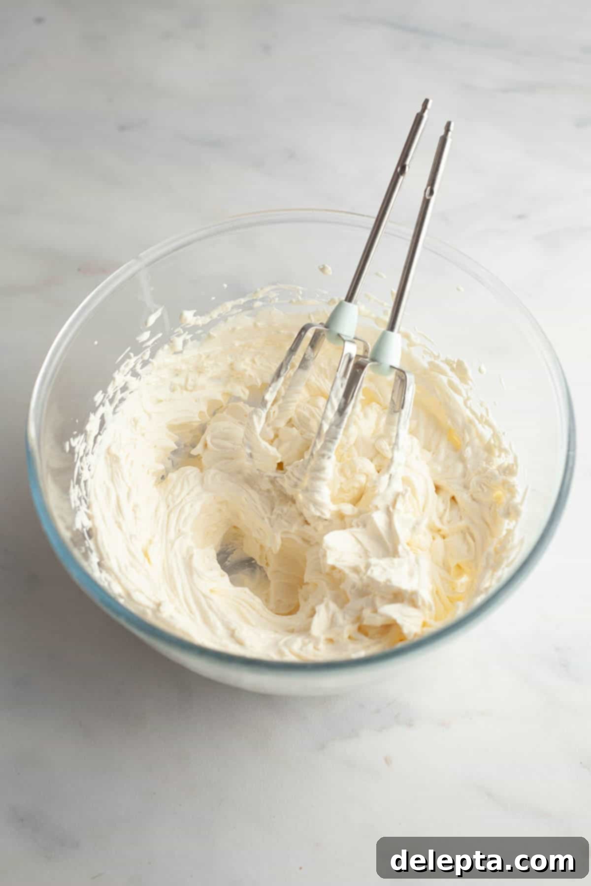Perfect Butter-Free Cream Cheese Frosting in Minutes 5 A bowl with finished cream cheese frosting, smooth and ready to be used.
