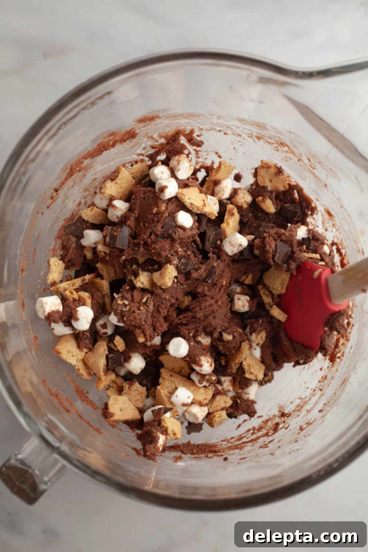Fireside S'mores Cookie Magic 6 Step 3: Folding in graham crackers, chocolate, and marshmallows.