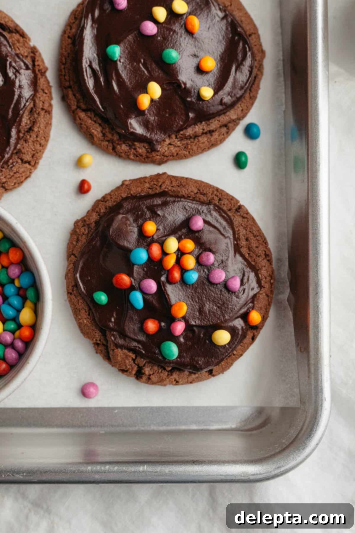 Galaxy Brownie Cookies 10 A finished plate of cosmic brownie cookies, each perfectly coated in chocolate ganache and vibrant rainbow chips.