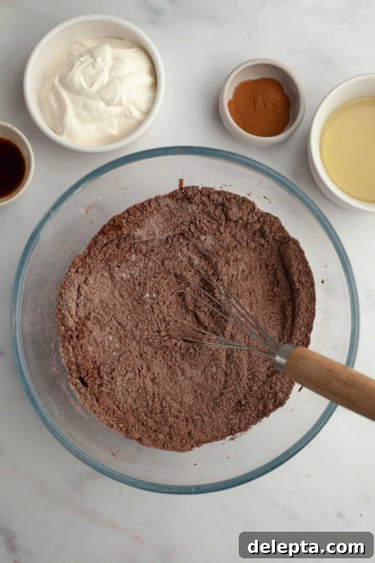 Decadent Chocolate Cream Cheese Cupcakes 4 A glass bowl with whisked flour and cocoa powder, representing dry ingredients.