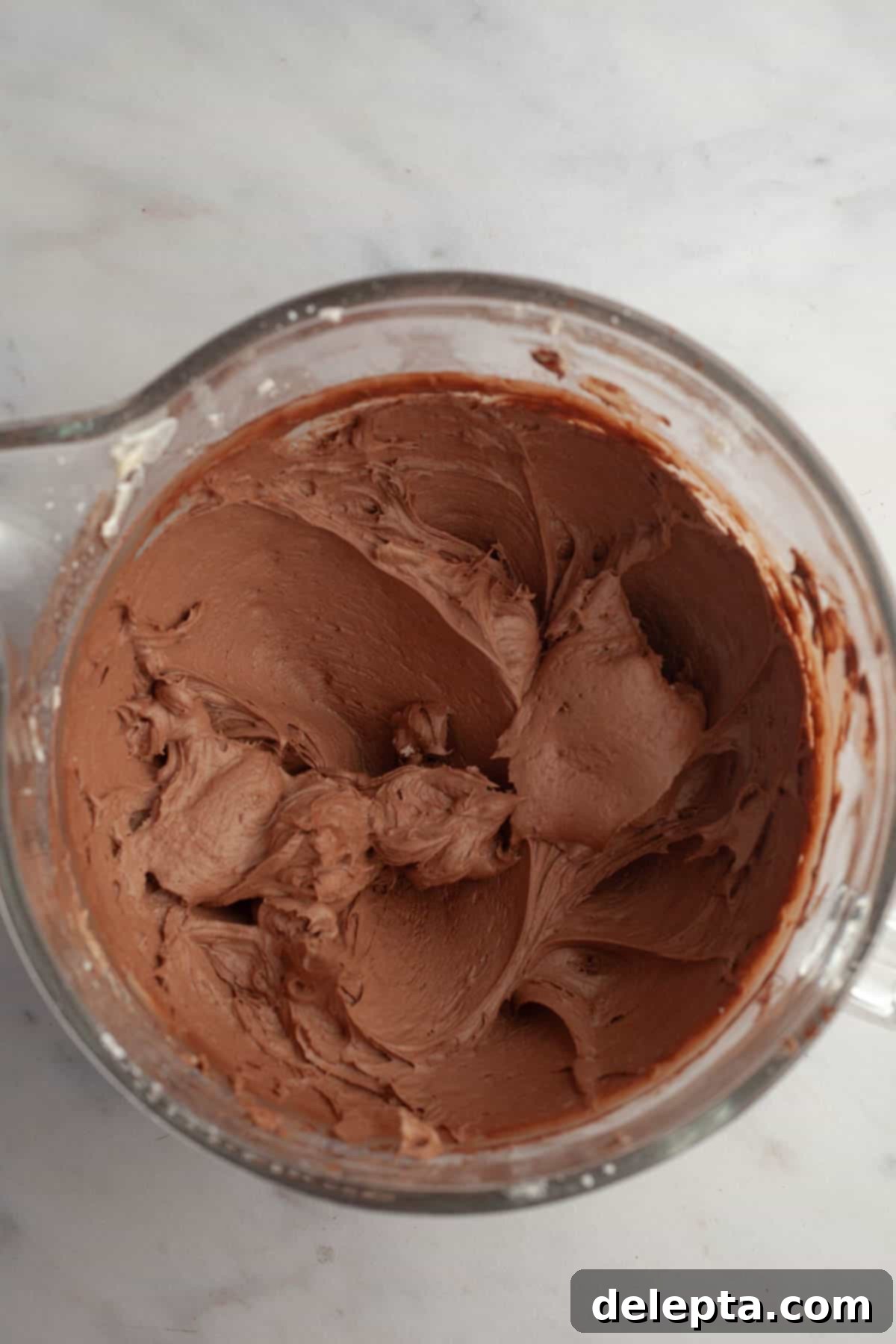 Decadent Chocolate Cream Cheese Cupcakes 9 A large mixing bowl with smooth, pipeable chocolate frosting.