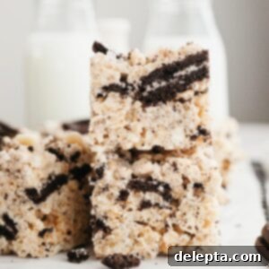Cookies and Cream Krispie Bars 9 A stack of two delicious Oreo Rice Krispie Treats, showcasing their gooey texture and delightful cookies and cream bits.