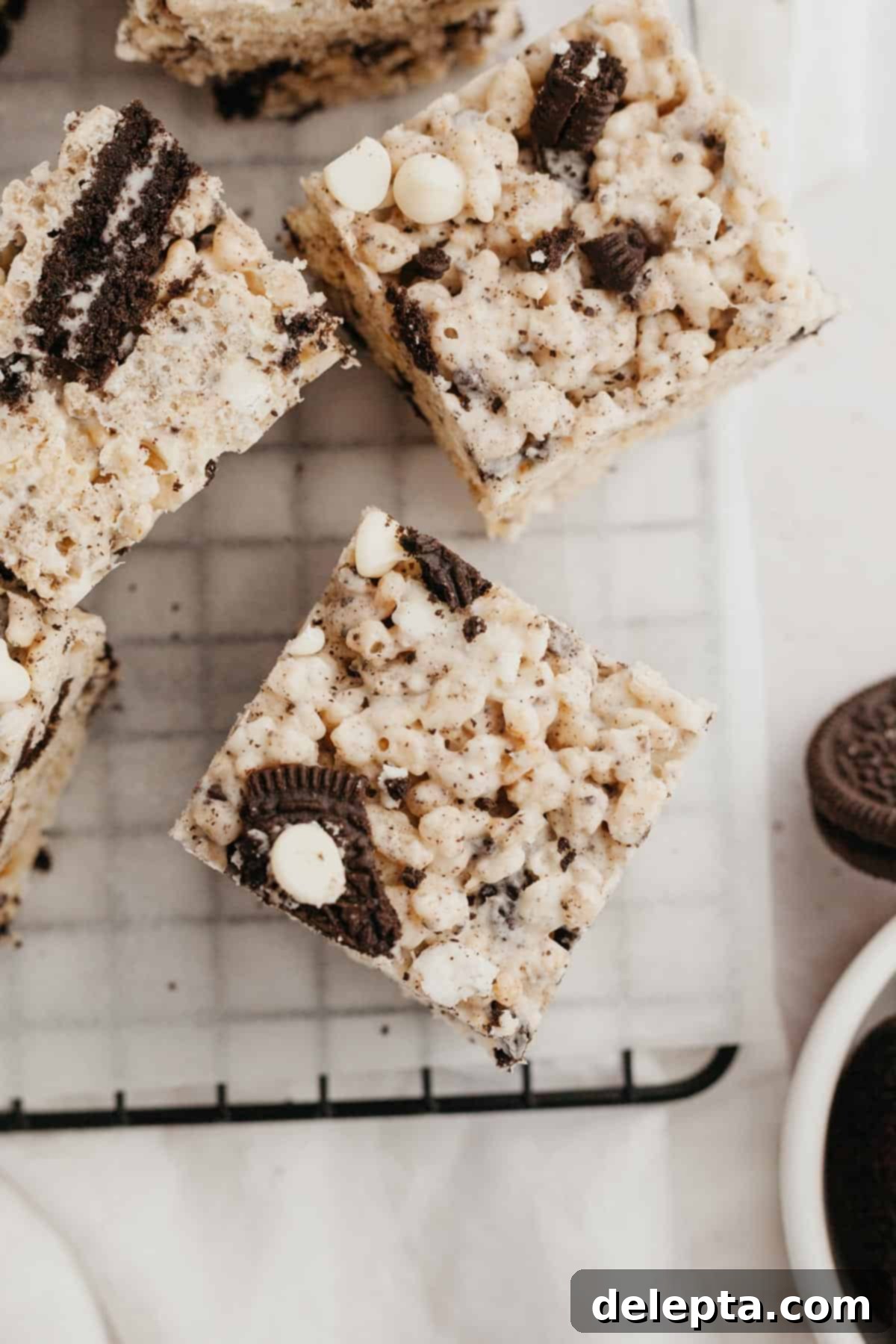 Cookies and Cream Krispie Bars 8 A beautifully presented block of Oreo Rice Krispie Treats on parchment paper, ready to be served or stored.