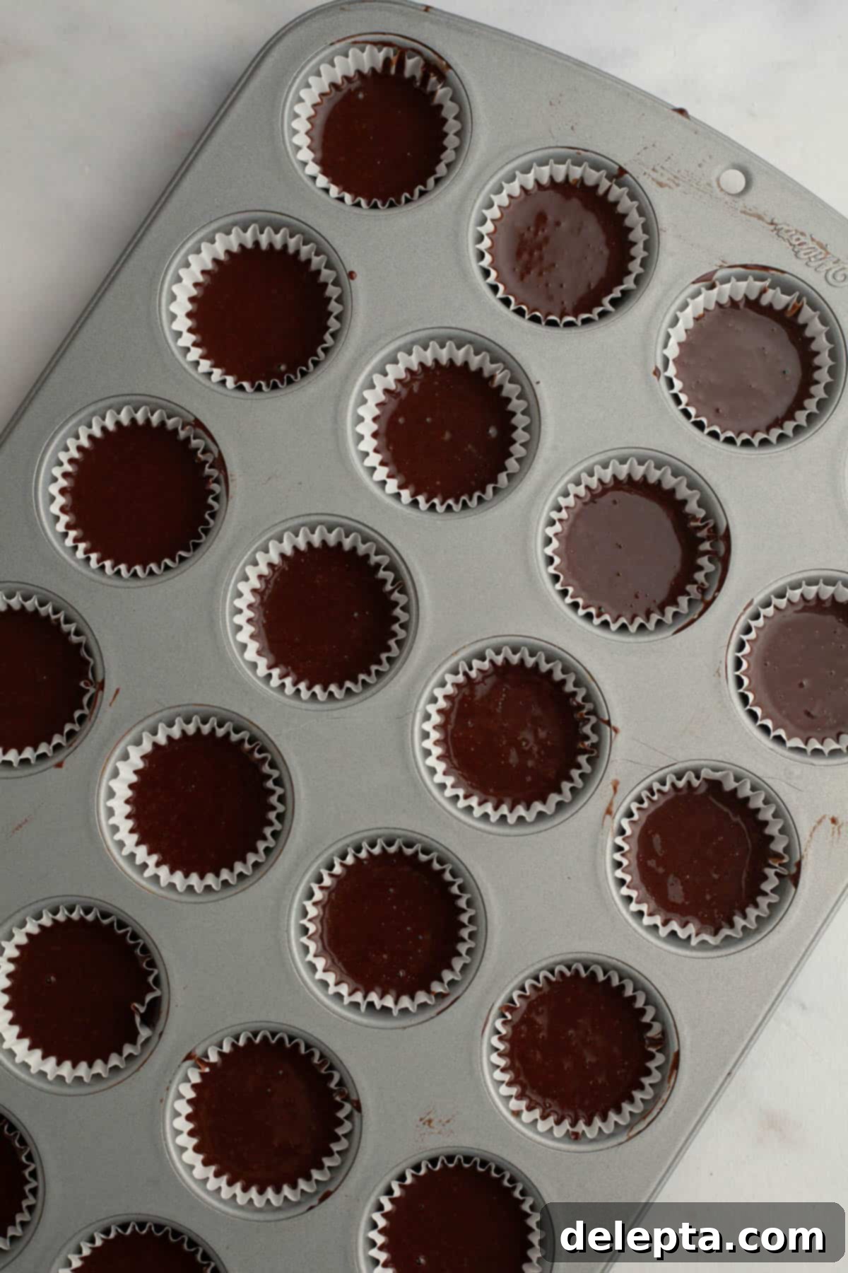 Irresistible Mini Chocolate Cupcakes: Effortlessly Moist Perfection 7 Unbaked mini chocolate cupcakes.
