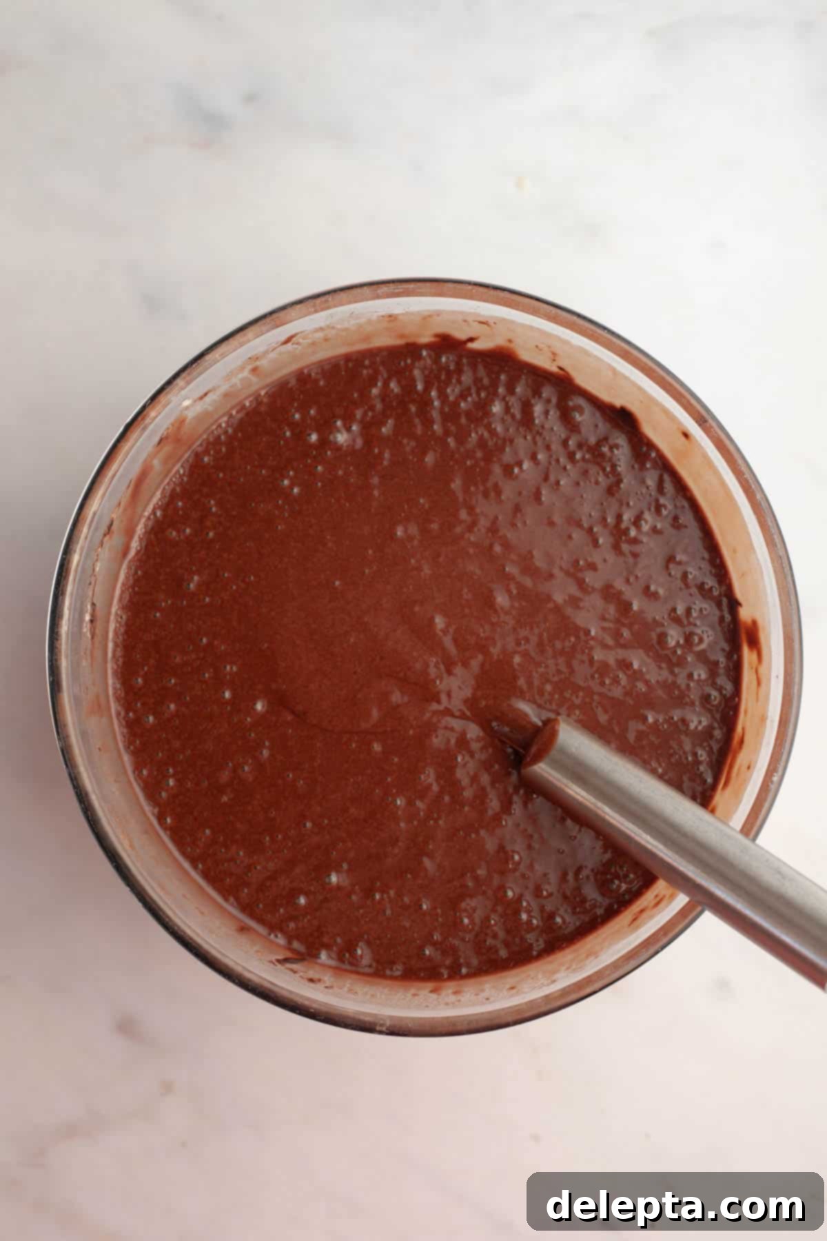 Simple Mocha Delight 6 A large glass bowl filled with rich, dark chocolate cake batter, ready for the next step.